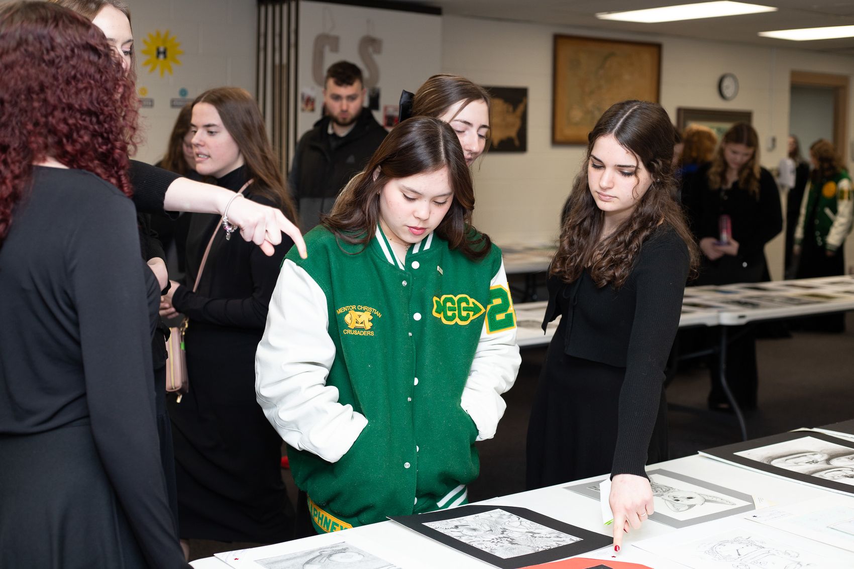 Students viewing artwork at a State Line student art display
