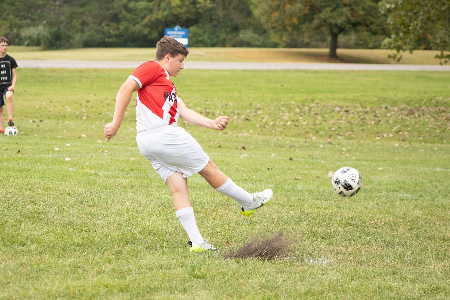 A State Line Patriots player striking a soccer ball